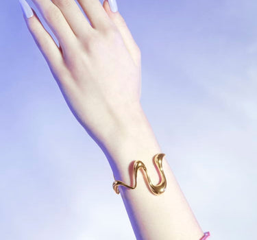 Bracciale rigido "Liquid" in oro